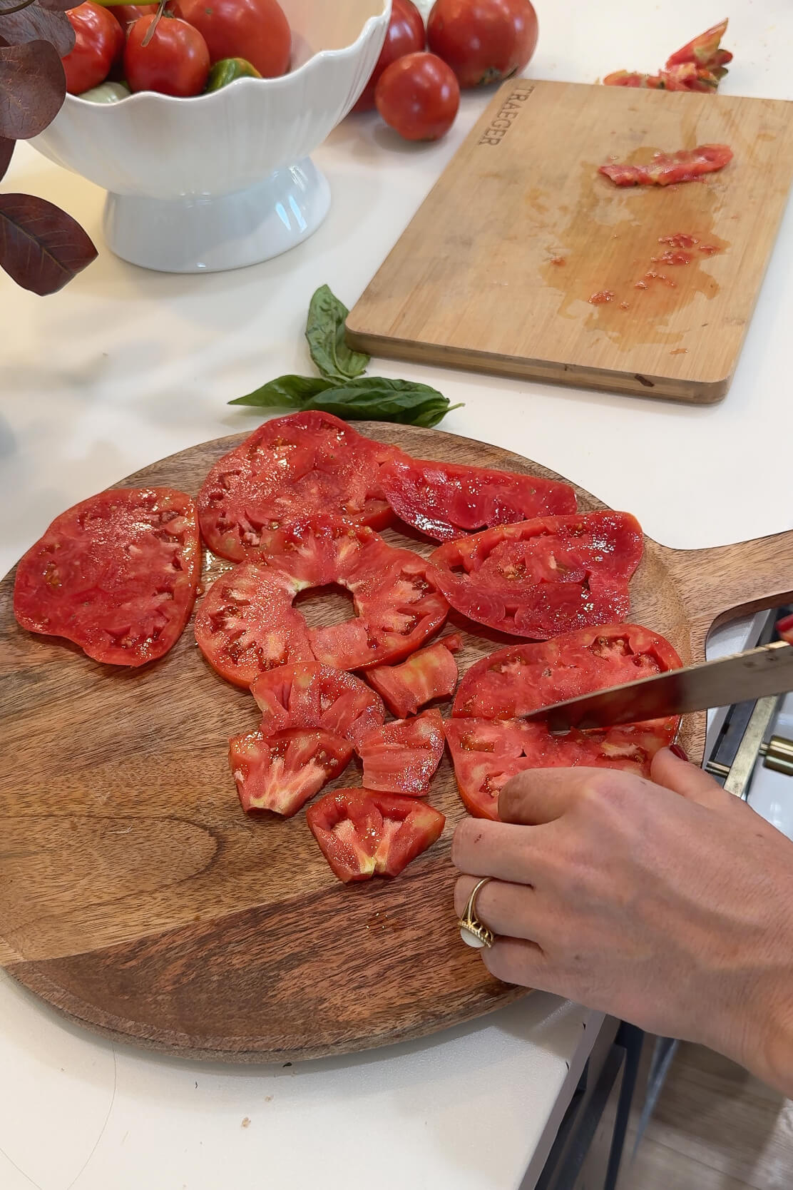 Cutting tomatoes for Caprese salad.